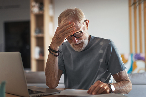 Photo of a worried man at his computer
