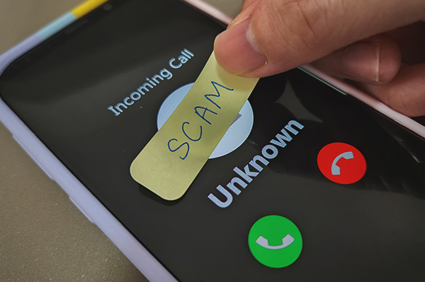 Photo of scammer holding phone