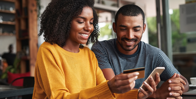 Photo of a couple using a computer