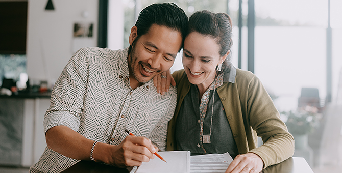 Photo of a couple working on their finances.