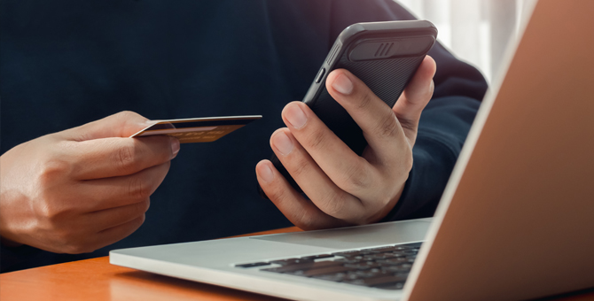 Photo of a person online shopping with a credit card