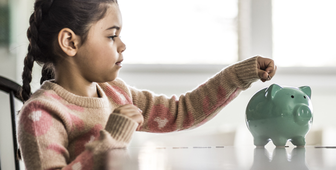 Photo of girl with her piggy bank