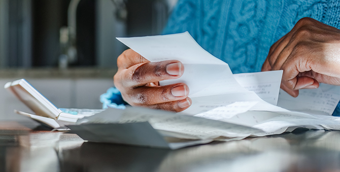 Photo of a woman paying monthly bills.