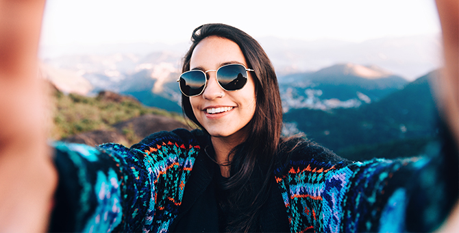 Photo of a young woman taking a selfie.