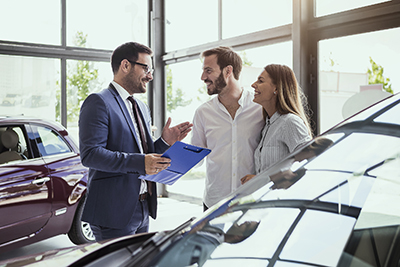 Couple buying car at a car dealership