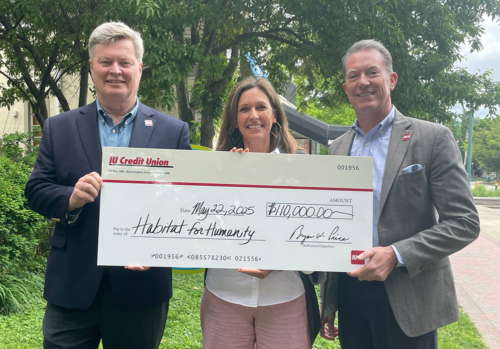 Photo of IUCU employees presenting large check to Habitat for Humanity of Monroe County representative