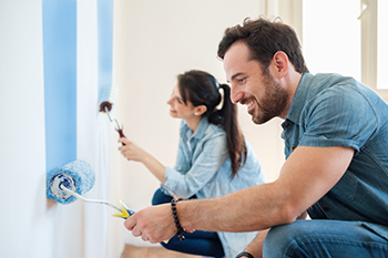 Photo of couple painting walls